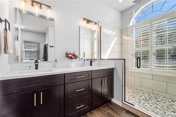 a bathroom with a shower and a sink