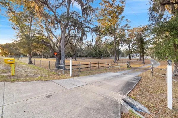 a front view of a house with a garden and yard