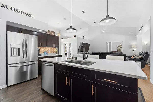 a kitchen with stainless steel appliances granite countertop a stove sink and cabinets