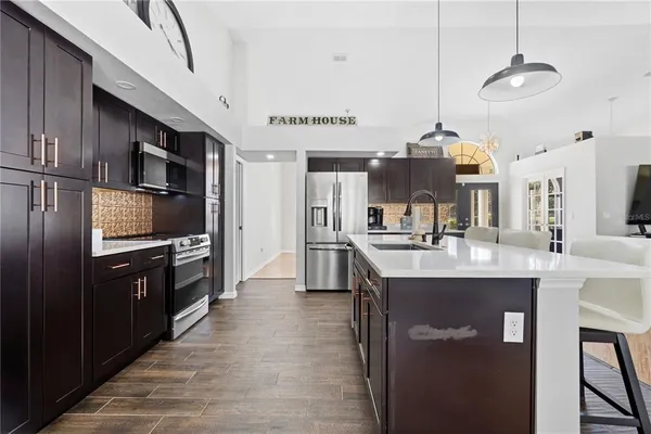 a kitchen with cabinets and chairs
