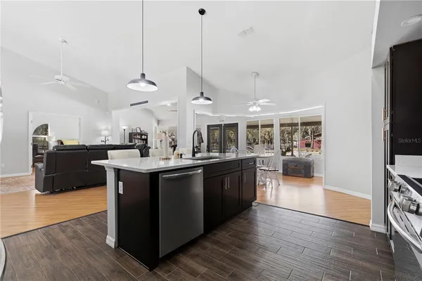 a kitchen with stainless steel appliances granite countertop a sink and cabinets