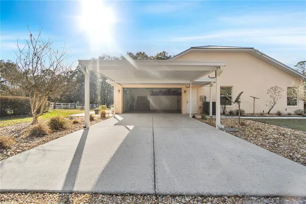 a view of a hallway with a room that has a bed and a view of bathroom
