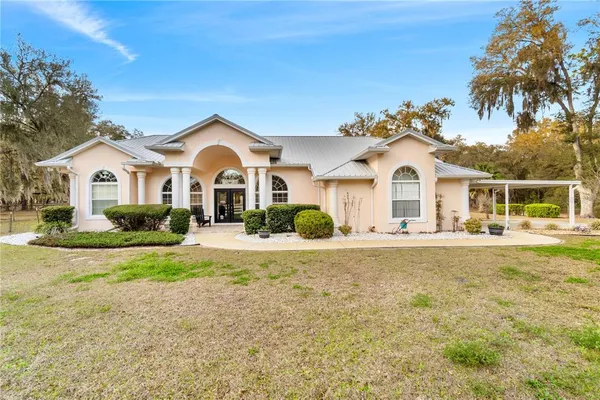 a spacious bedroom with a bed a couch and dresser