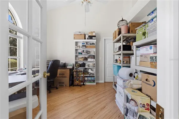 a living room with furniture a chandelier and a flat screen tv