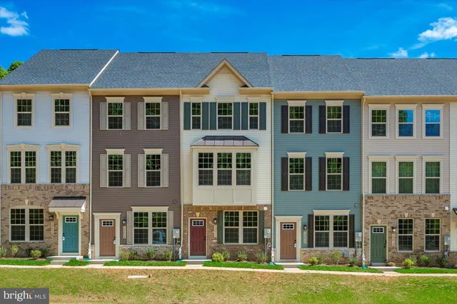 a front view of a residential apartment building with a yard