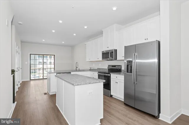 a kitchen with a sink stove and microwave