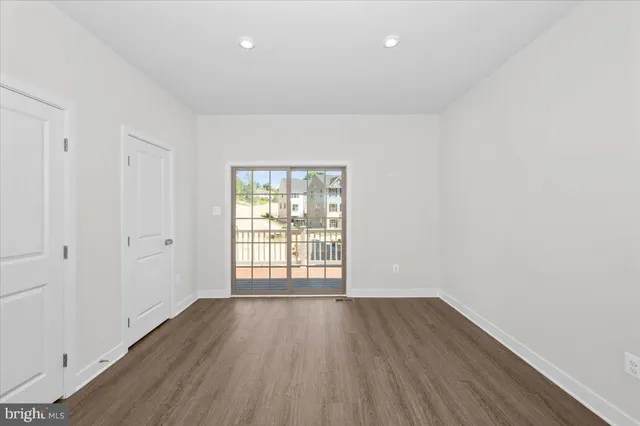 a view of kitchen with stainless steel appliances granite countertop a stove top oven a sink and dishwasher with wooden floor