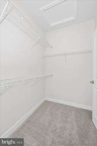 a bathroom with a toilet sink vanity and mirror