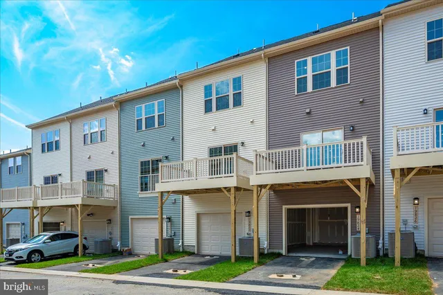 a front view of a building with a garden