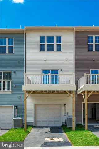 a front view of a building with a garden