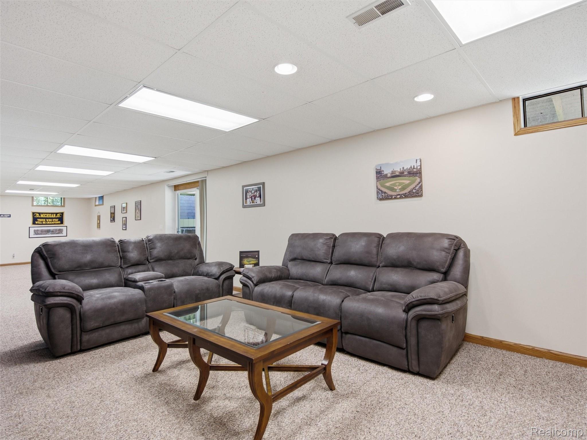 5003 Mason Road Howell, MI 48843 - Photo 25 of 59 Spacious lower-level room featuring neutral-toned carpeting, ample recessed lighting, and drop ceiling panels