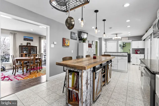 a kitchen with stainless steel appliances granite countertop a stove and a refrigerator