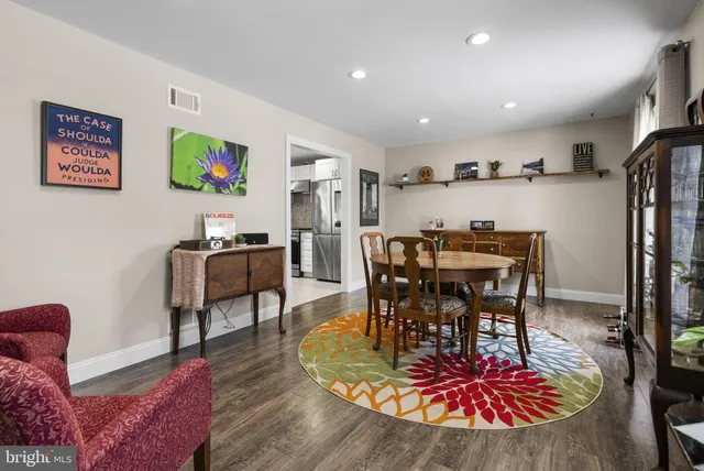 a living room with furniture a dining table and kitchen view
