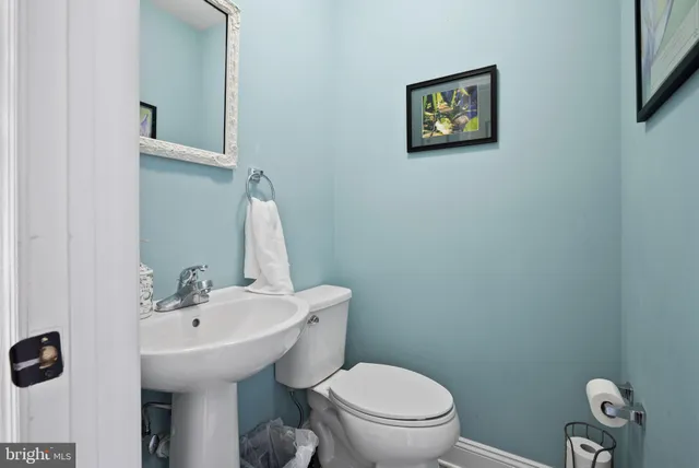 a bathroom with a sink mirror and toilet