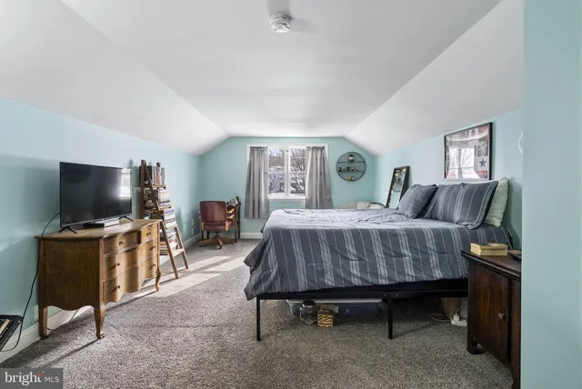 a bedroom with a bed and a flat screen television