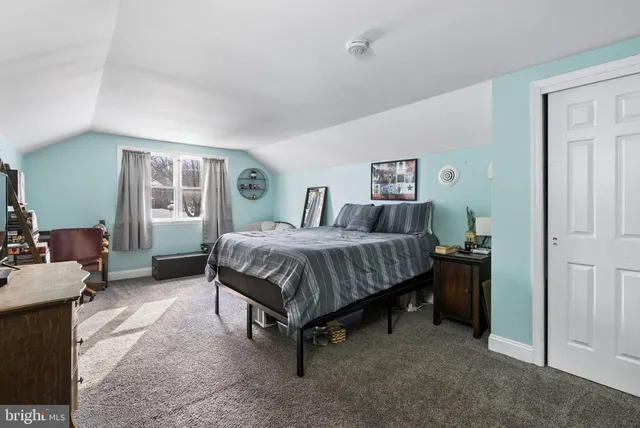 a spacious bedroom with a bed and a table in it