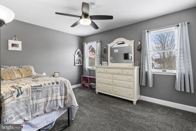 a bedroom with a bed a chandelier and a window