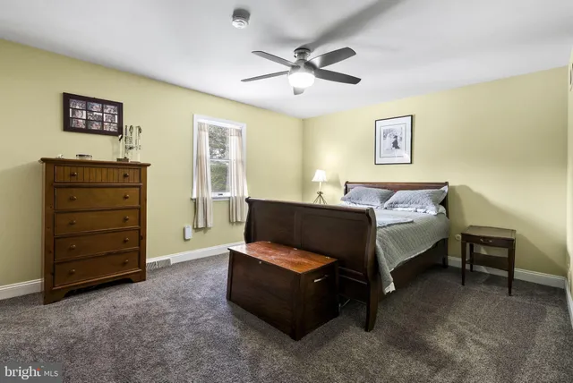 a living room with furniture and a ceiling fan