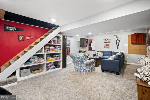 a living room with furniture and a book shelf