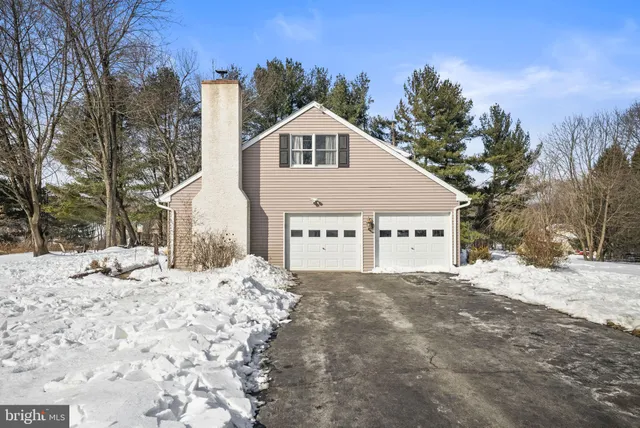 a view of a house with a yard covered in snow
