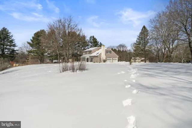 a view of white house with a snow on the road