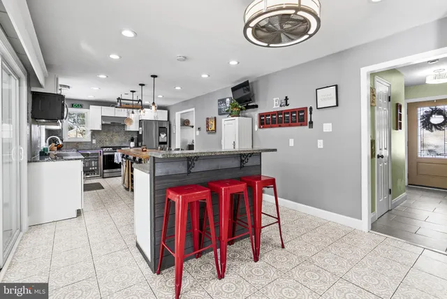a kitchen with stainless steel appliances kitchen island granite countertop a sink and cabinets