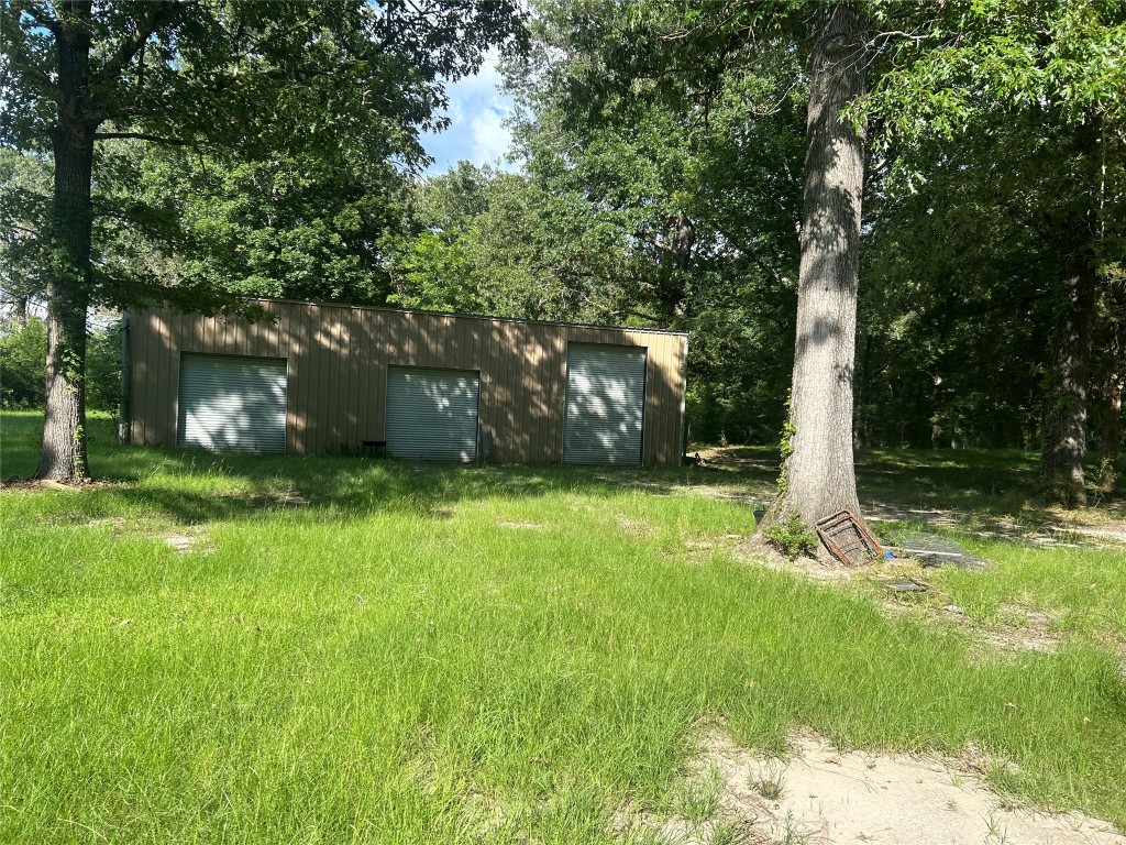 164 Parker Road Corrigan, TX 75939 - Photo 21 of 34 a view of a backyard with large trees