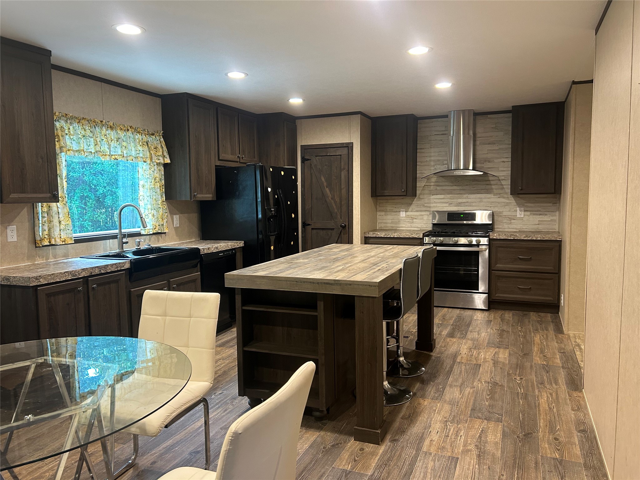 164 Parker Road Corrigan, TX 75939 - Photo 8 of 34 a kitchen with stainless steel appliances granite countertop a sink stove refrigerator and chairs