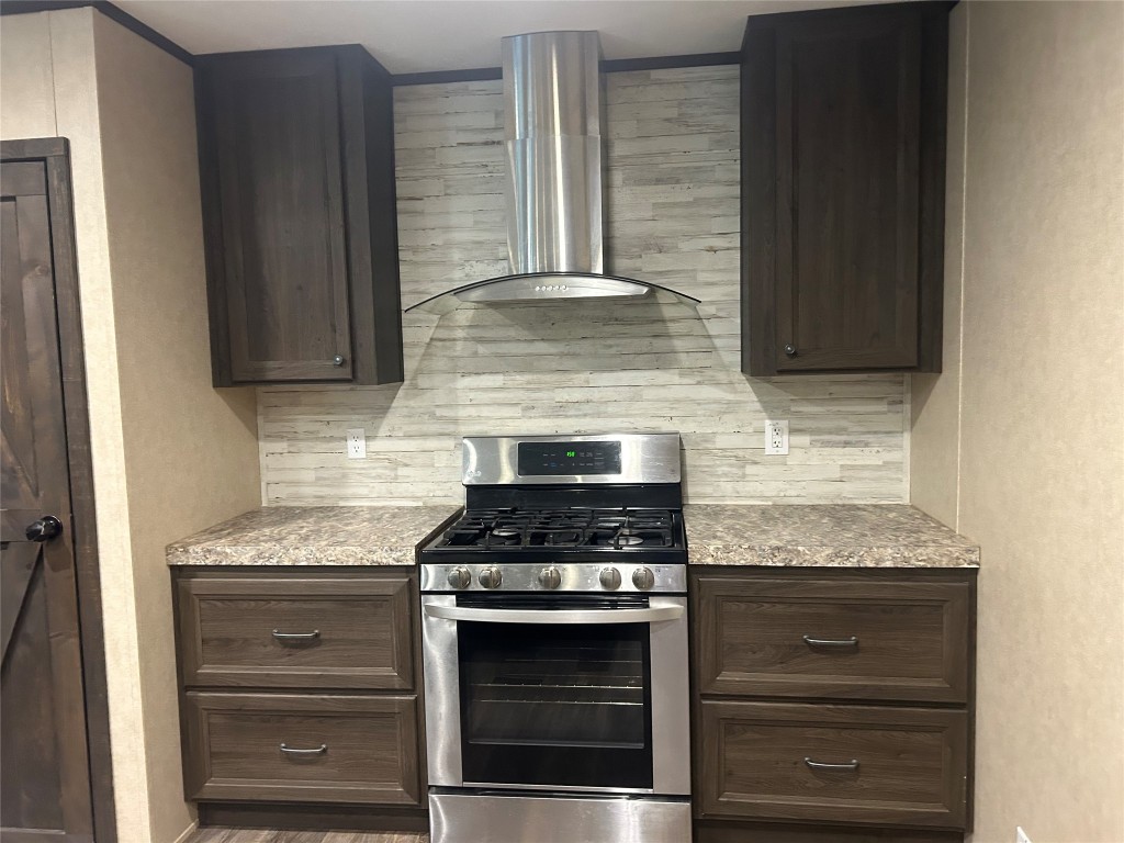 164 Parker Road Corrigan, TX 75939 - Photo 10 of 34 a kitchen with granite countertop cabinets and steel stove