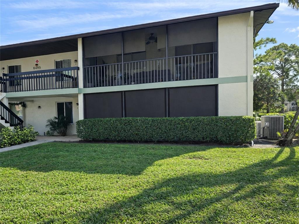 a view of a house with a yard and sitting area
