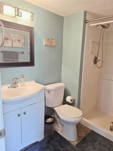 a bathroom with a toilet sink and shower
