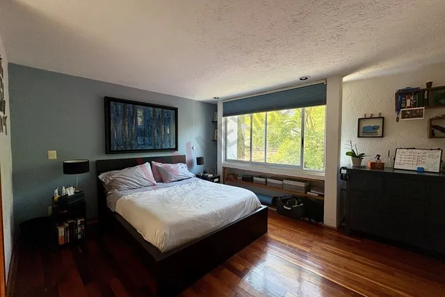 a bedroom with a bed and a window