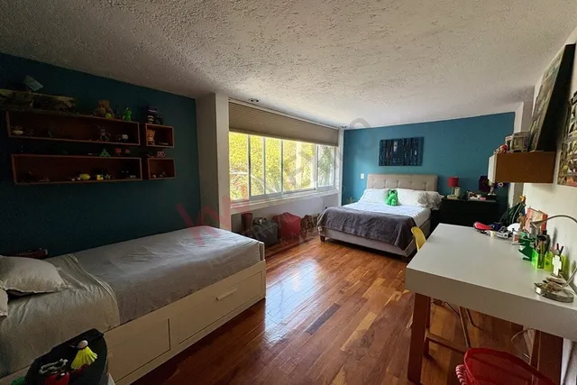 a bedroom with two beds and a large window