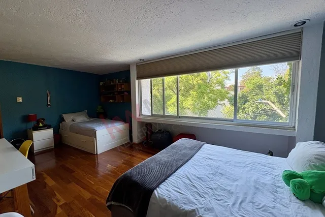 a bedroom with a large bed and a large window