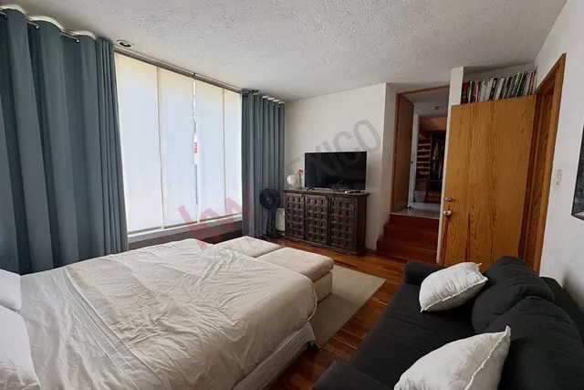 a bedroom with a bed and furniture