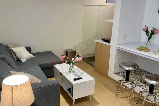 a living room with furniture and a table