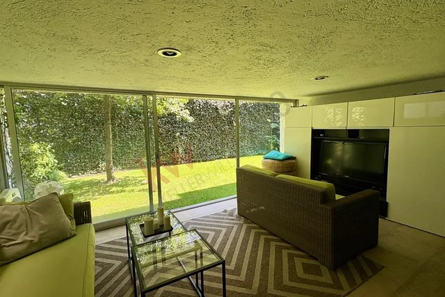 a living room with fireplace furniture and a flat screen tv