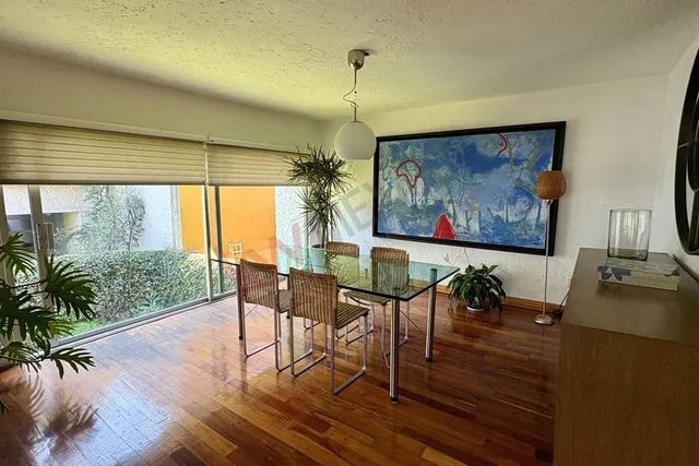 a dining room with wooden floor glass table and chairs