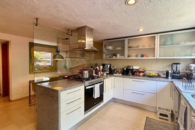 a kitchen with stainless steel appliances granite countertop a stove and a sink