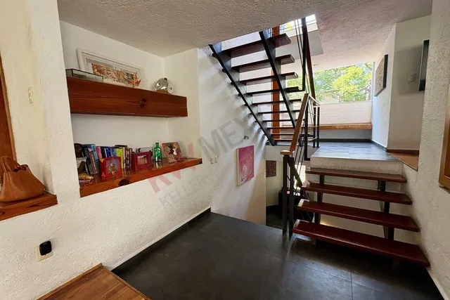 a view of a livingroom with furniture and staircase