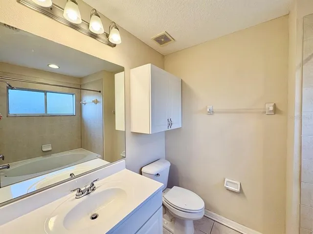 a bathroom with a sink a toilet and mirror