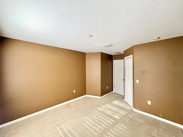 a view of a big room with closet and chandelier fan