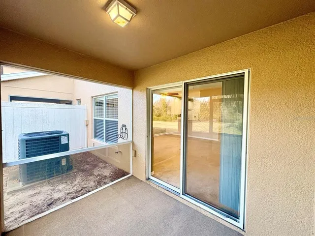 a view of an empty room with a fireplace and a window
