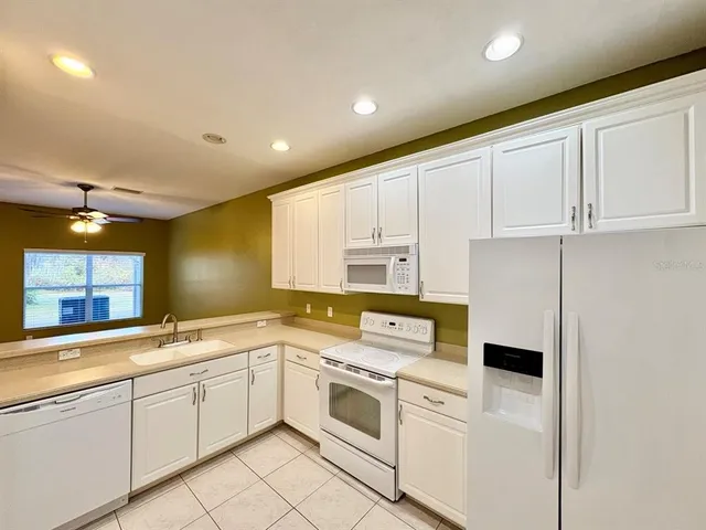 a kitchen with a white cabinets and white appliances