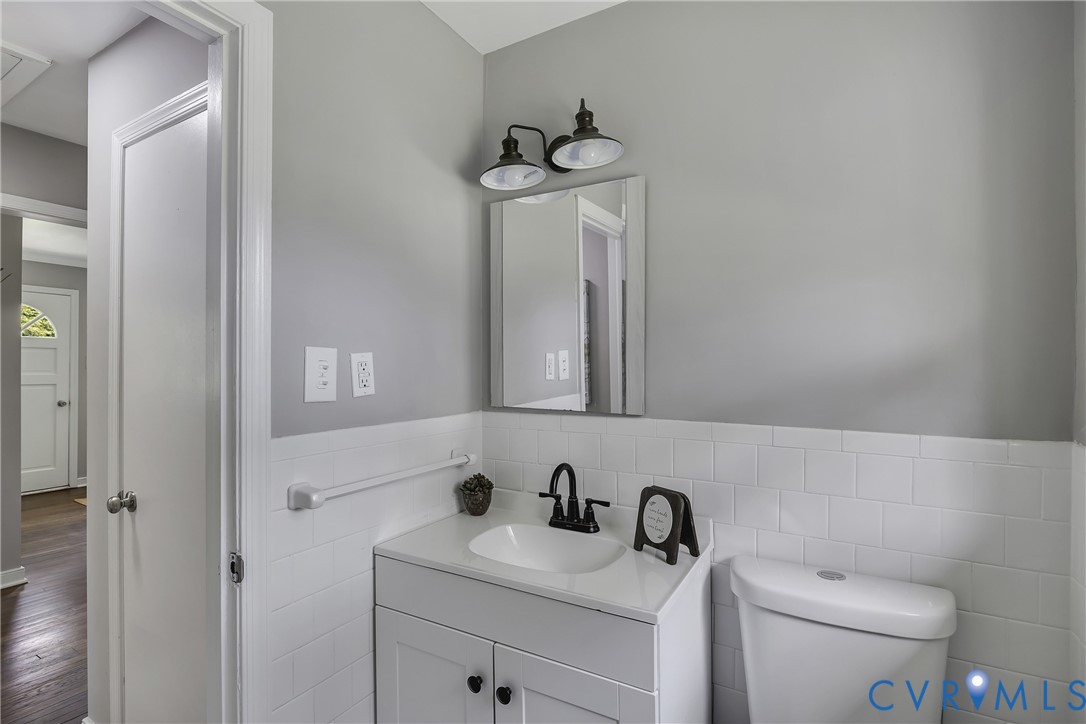 5702 West Rois Road Richmond, VA 23227 - Photo 15 of 22 a bathroom with a toilet a sink a vanity and mirror