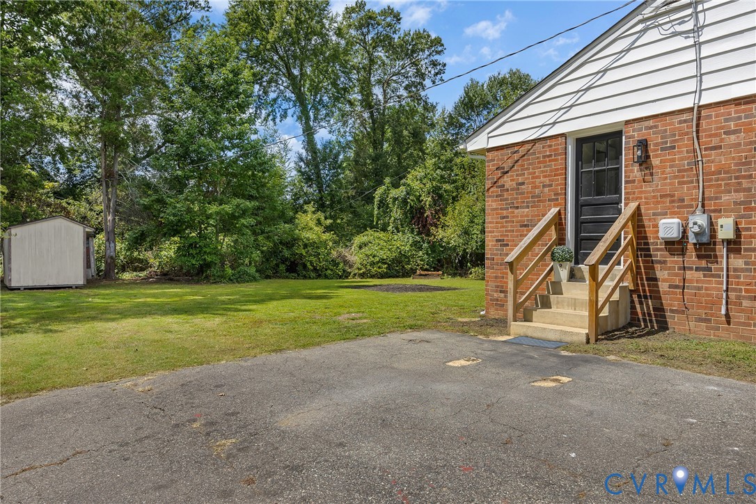 5702 West Rois Road Richmond, VA 23227 - Photo 19 of 22 a view of a house with backyard and a tree