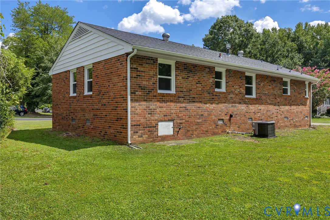 5702 West Rois Road Richmond, VA 23227 - Photo 20 of 22 a view of a house with a yard