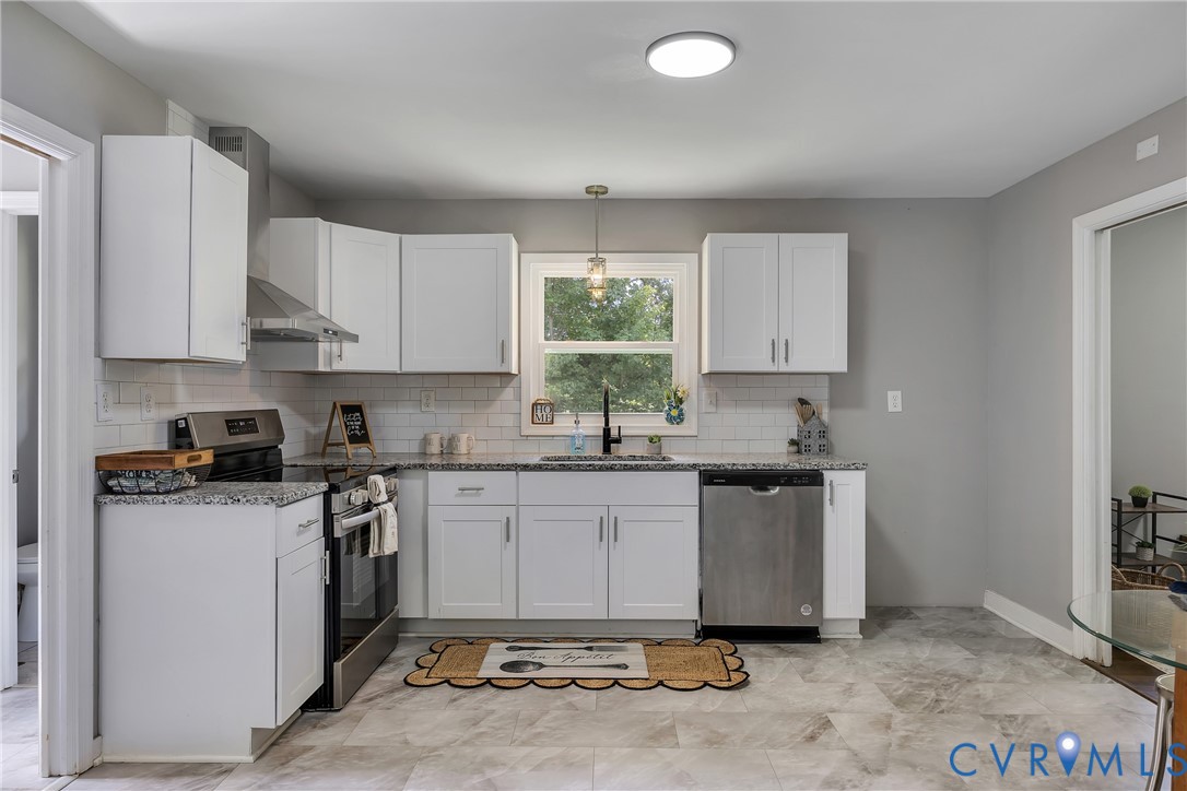 5702 West Rois Road Richmond, VA 23227 - Photo 8 of 22 a kitchen with a sink cabinets and window