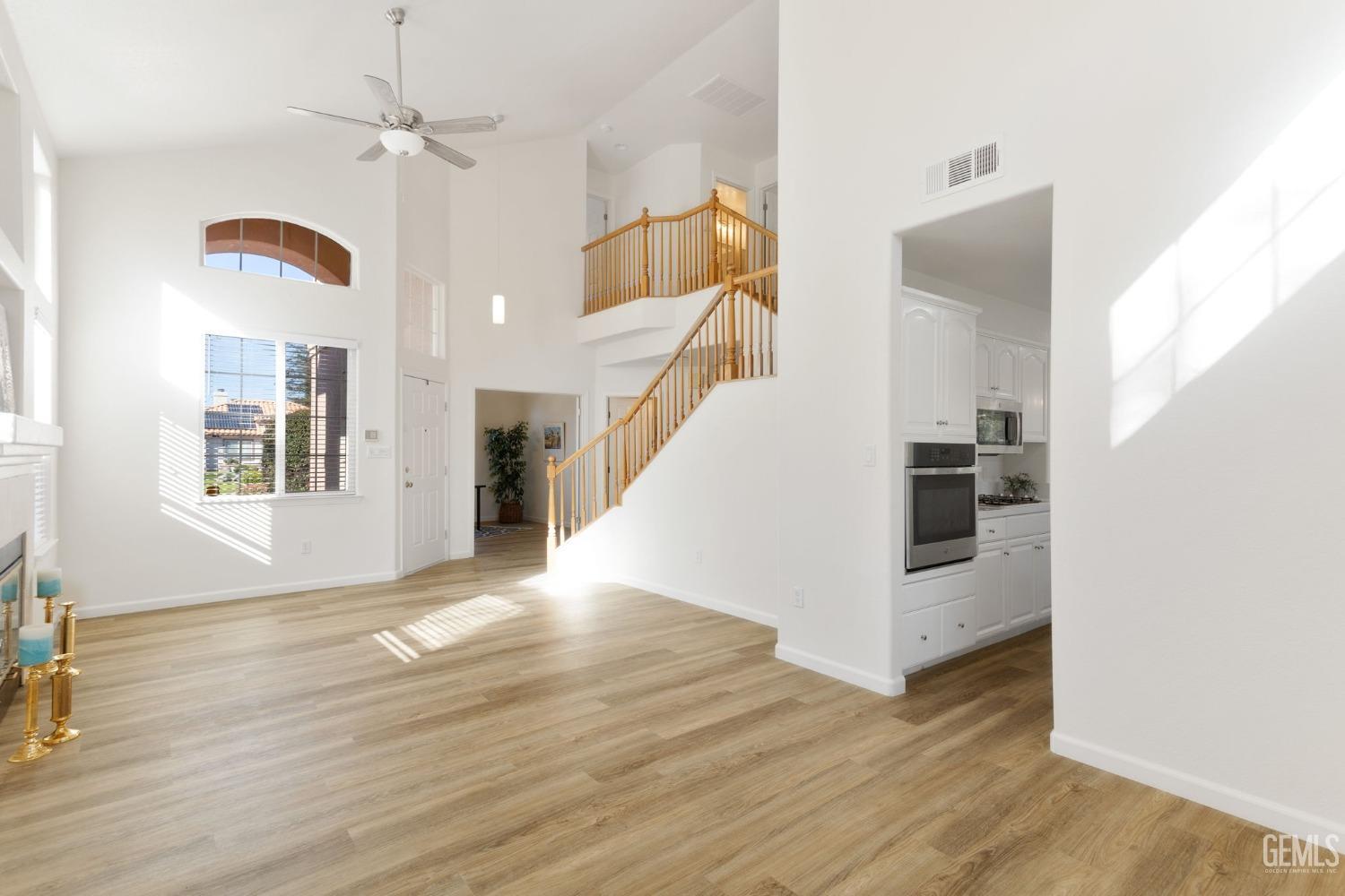Undisclosed Address Bakersfield, CA 93311 - Photo 12 of 52 a view of a livingroom with wooden floor and stairs