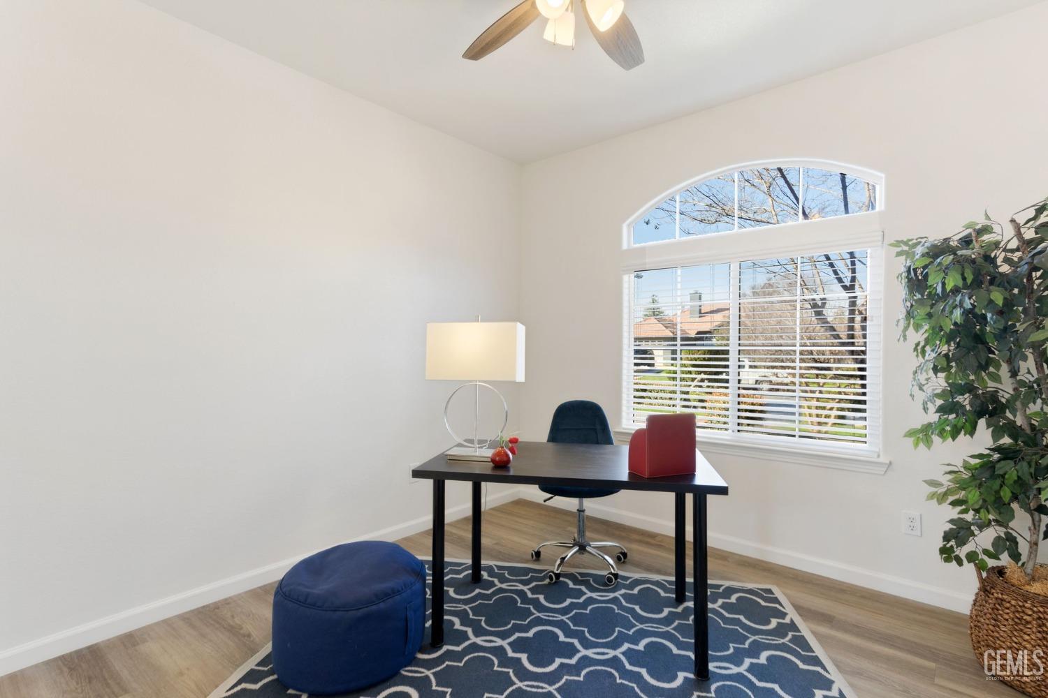 Undisclosed Address Bakersfield, CA 93311 - Photo 15 of 52 a workspace with furniture and a potted plant